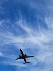 Airplane landing with a clouds background