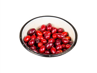 Red berries of a dogwood plant in an iron bowl on a white background. Cornus mas. Fruit berries. Harvesting. Agricultural gardening. Kitchenware. Vitamin dessert.
