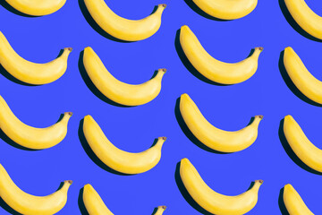 Pattern of ripe yellow bananas on a blue background