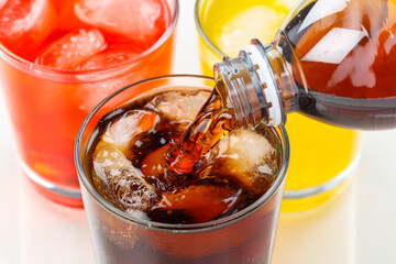 Pouring cola drink drinks lemonade softdrinks in a glass - obrazy, fototapety, plakaty