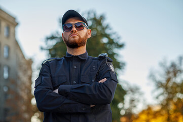 Police officer poses in uniform and sunglasses