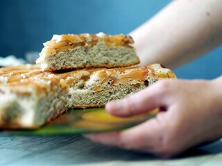 Still life with apple summer charlotte with fresh apples and bran on a table with a blue background. Diet baking