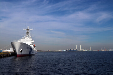 Obraz premium Japan Coast Guard Patrol boat moored at the port. 横浜赤レンガ倉庫前の臨海公園からベイブリッジ、海上保安庁の船艇を入れた風景画像。