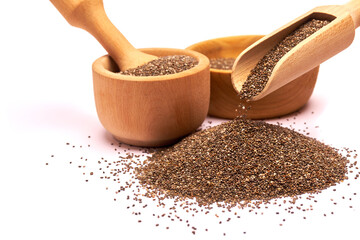 Wooden scoop of organic natural chia seeds close-up isolated on white background