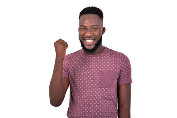 young happy man raising his arm smiling.