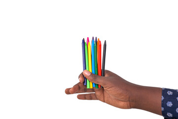 hand of a young man holding colored pencils.
