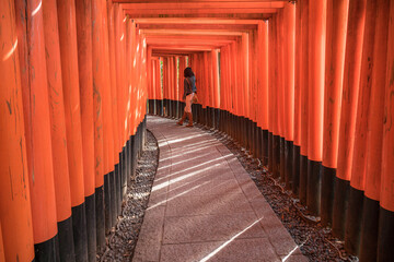 People visit Fushimi Inari Taisha, the Shinto shrine located in Fushimi-ku, Kyoto, Japan. Senbon Torii is an impressive pathway with about a thousand torii gates.