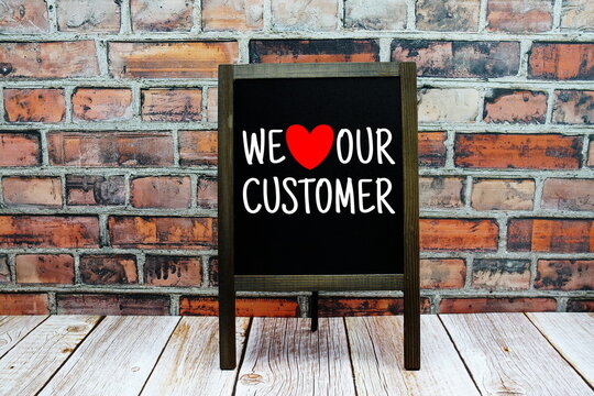 We Love Our Customer typography text on easel blackboard
