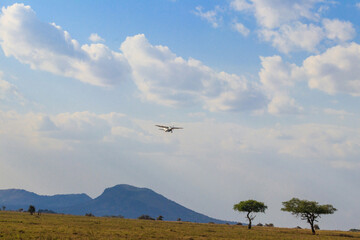 Airplane flying over the african savanna in Serengeti national park, Tanzania