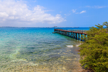 Obraz premium Wooden pier leading to clear blue ocean on Prison island, Zanzibar, Tanzania