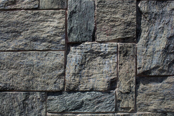 evocative image of granite wall with joints between tiles