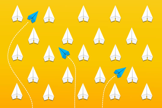 Group of paper plane in one direction with one group of blue individual pointing in the different way on yellow background. Business concept for new ideas creativity, innovative and solution.