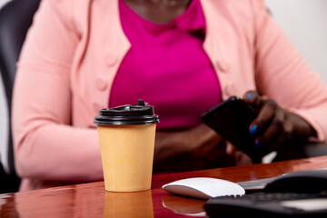 cup of coffee lying on an office table.