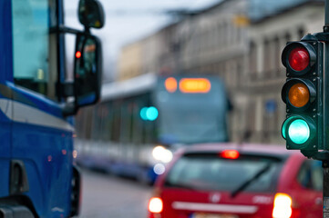 traffic light on the street junction with beautiful bokeh, city with cars in the background
