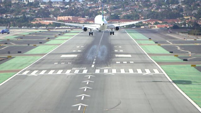 plane lands on large runway 