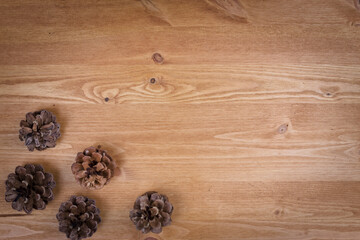 wooden background with pine cones, autumn
