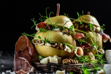 Prosciutto or spanish jamon with pears, camembert, walnut and microgreen. Food recipe background