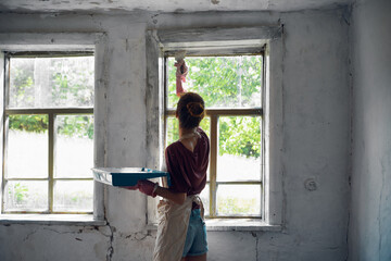Obraz na płótnie Canvas woman paints house renovation interior room painter