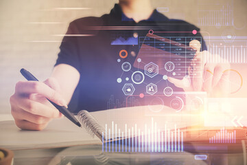 Double exposure of man hands holding a credit card and data theme drawing. E-commerce and technology concept.