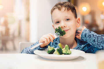 boy eating broccoli, healthy food
