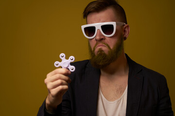 man wearing sunglasses spinner in hands fashion posing black jacket