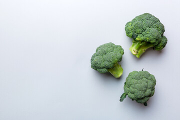 Top view fresh green broccoli vegetable on Colored background. Broccoli cabbage head Healthy or vegetarian food concept. Flat lay. Copy space