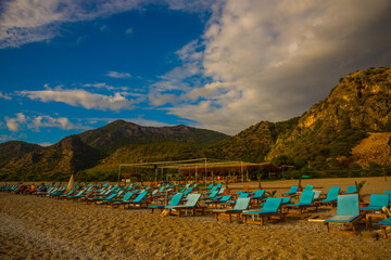OLUDENIZ, TURKEY: Beautiful landscape with Sun Loungers on Oludeniz beach.