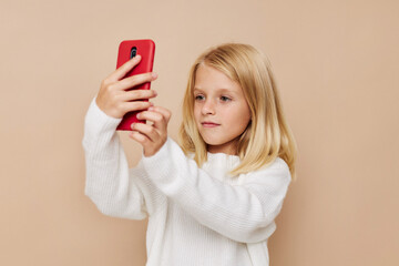 Portrait of a smiling little cutie talking on the phone technology posing studio