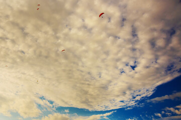 OLUDENIZ, TURKEY: Paragliding in the sky in the clouds over the beach in Oludeniz.