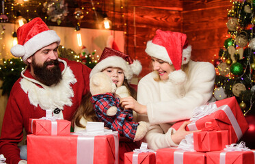 Fototapeta na wymiar Christmas traditions concept. Father Santa claus costume with mom and little kid celebrating christmas. Christmas is the time to please. Joyful people. Gifts from Santa. Lovely daughter with parents
