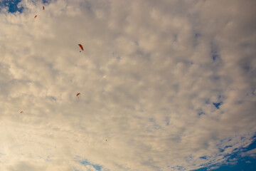 OLUDENIZ, TURKEY: Paragliding in the sky in the clouds over the beach in Oludeniz.