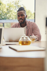 Worried man seated at his notebook computer