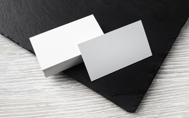 Photo of blank business cards on stone board. Template for ID.