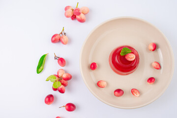 Jelly dessert with Fresh organic Carunda or Karonda fruits on white background