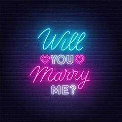 Will You Marry Me neon lettering on brick wall background.