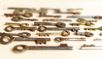 Antique keys are commonly reffered to as a bit or barrel keys, the former having a solid shrank and the latter being hollow. Here are some old antique and vintage keys against paper background.