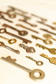 Antique keys are commonly reffered to as a bit or barrel keys, the former having a solid shrank and the latter being hollow. Here are some old antique and vintage keys against paper background.