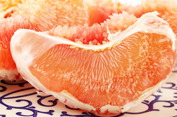 peeled pomelo pieces isolated on white background. Tasty fresh fruit eating concept