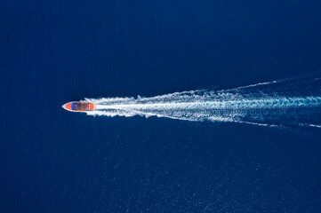 Fast boat at the sea in Bali, Indonesia. Aerial view of luxury floating boat on transparent...
