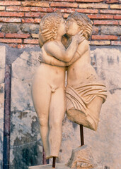 Beautiful statue of Cupid and Psyche illuminated by sunset lights shows carved in marble the...