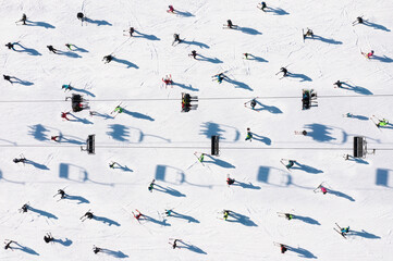 Ski resort. Aerial view of skiers and snowboarders. Winter sports.