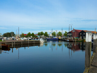 Fototapeta na wymiar A small harbor Kükhernster Feart water canal near Leeuwarden, Friesland, Netherlands