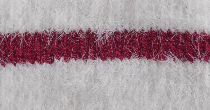 The texture of the knitted part is close-up. Macro fragment. White background.