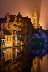 Naklejka premium Christmas in Bruges, Belgium. Romantic city in the evening fog. Travel and tourism in Europe