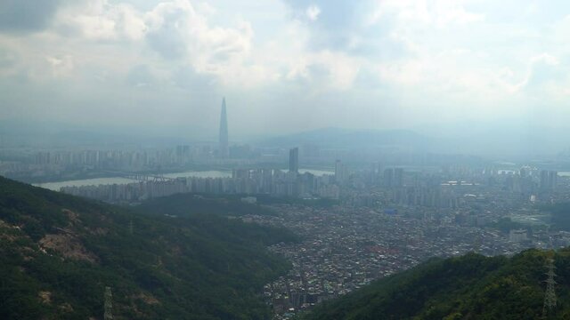 Seoul city skyline on hazy day with high levels of micro dust air pollution from Acha mountain peak  - Lotte Tower and Han river in background, climate change