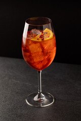 Bright aperol with spices. Cooling cocktail with ice. Orange mood. Relaxing drink. Glass with a beautiful cocktail
