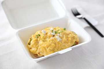 Avocado and scrambled eggs toast with delivery package in white background