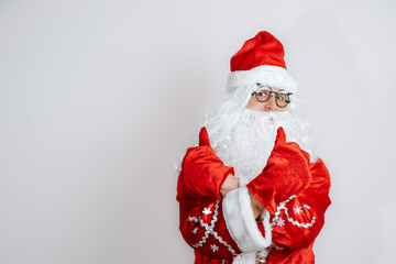 Portrait of Santa Claus showing Thumb-up on white background.