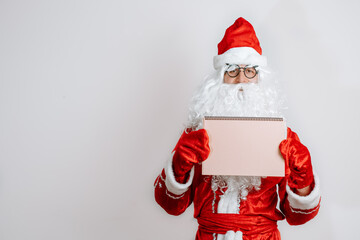 The kind Santa Claus holds an empty cardboard frame. Place for advertising, for text, empty space