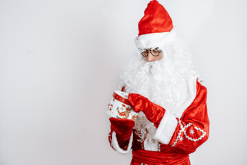Close-up portrait of Santa Claus holding Christmas Present.